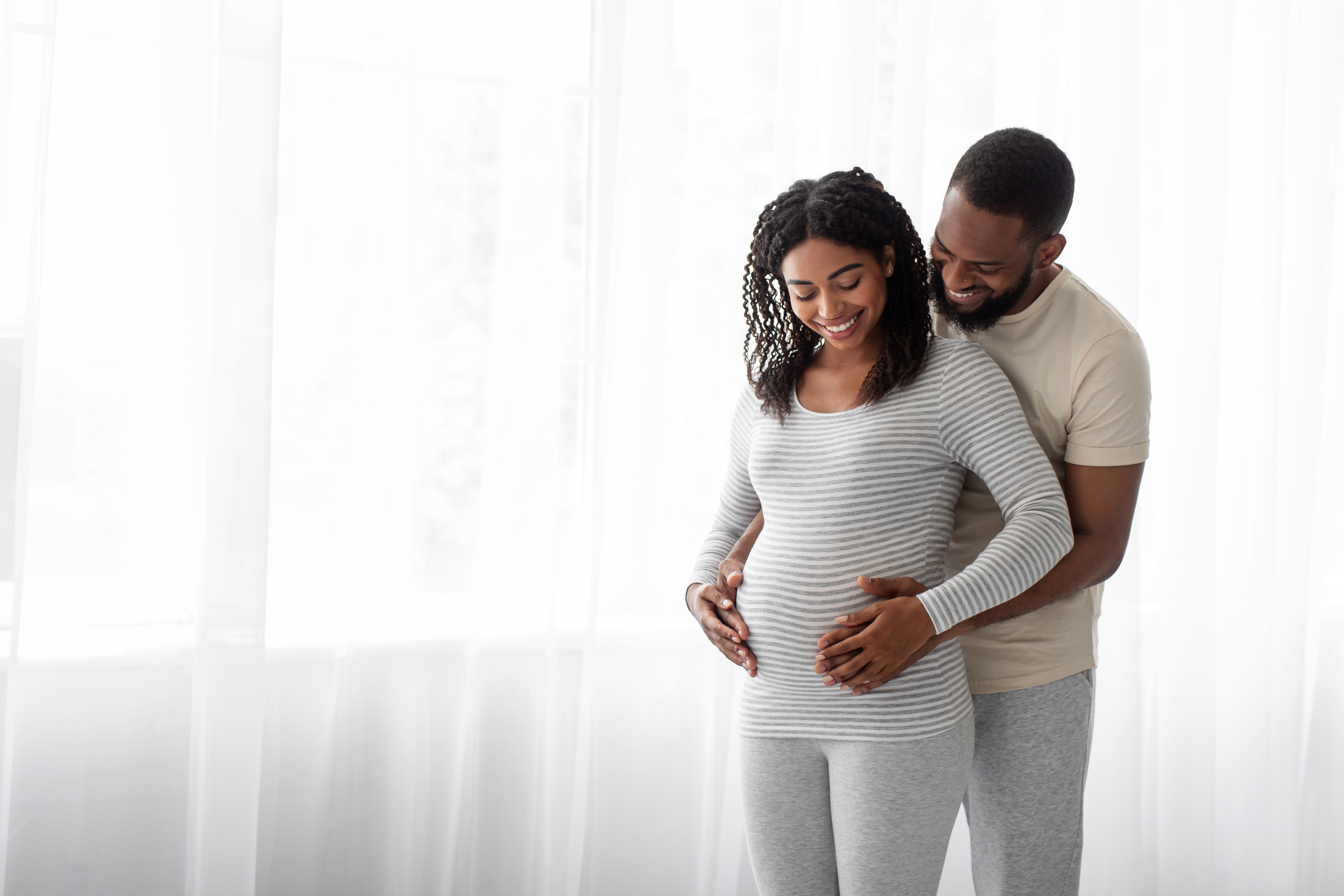Satisfied,Millennial,Black,Handsome,Hugs,Pregnant,Wife,In,Bedroom,Interior