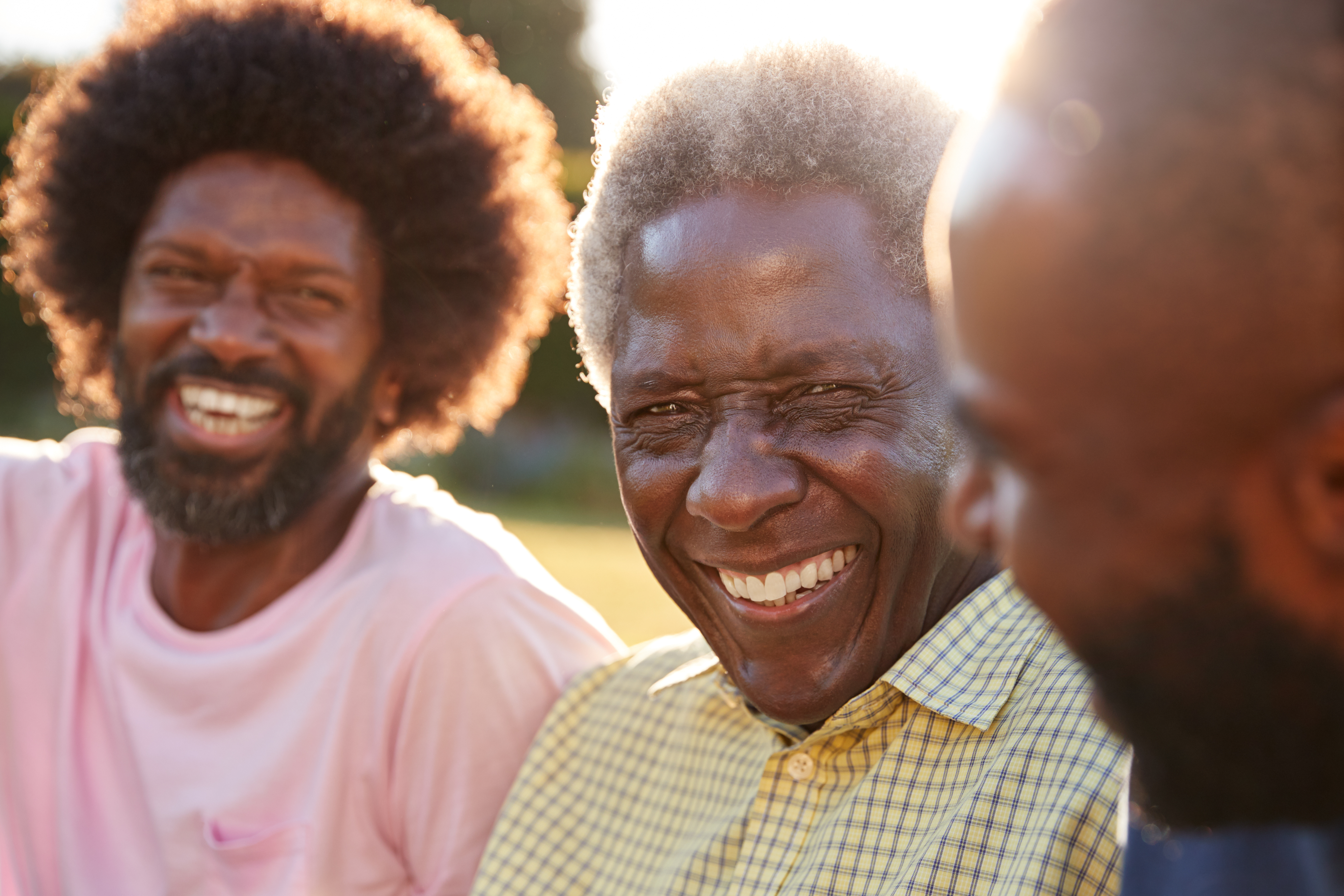Senior,Black,Man,Laughing,With,His,Two,Adult,Sons,,Close