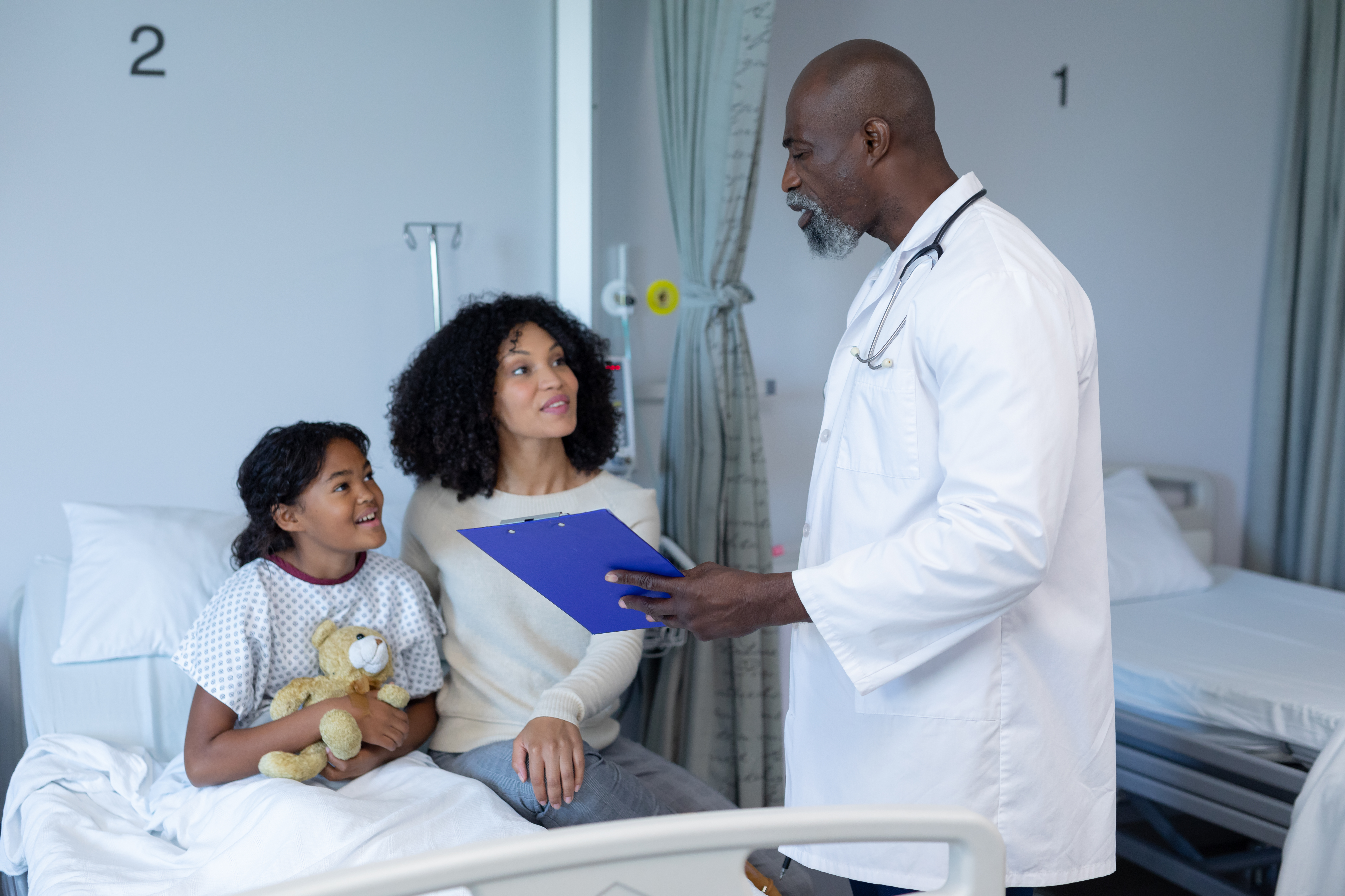 African,American,Male,Doctor,Talking,To,Mixed,Race,Mother,And