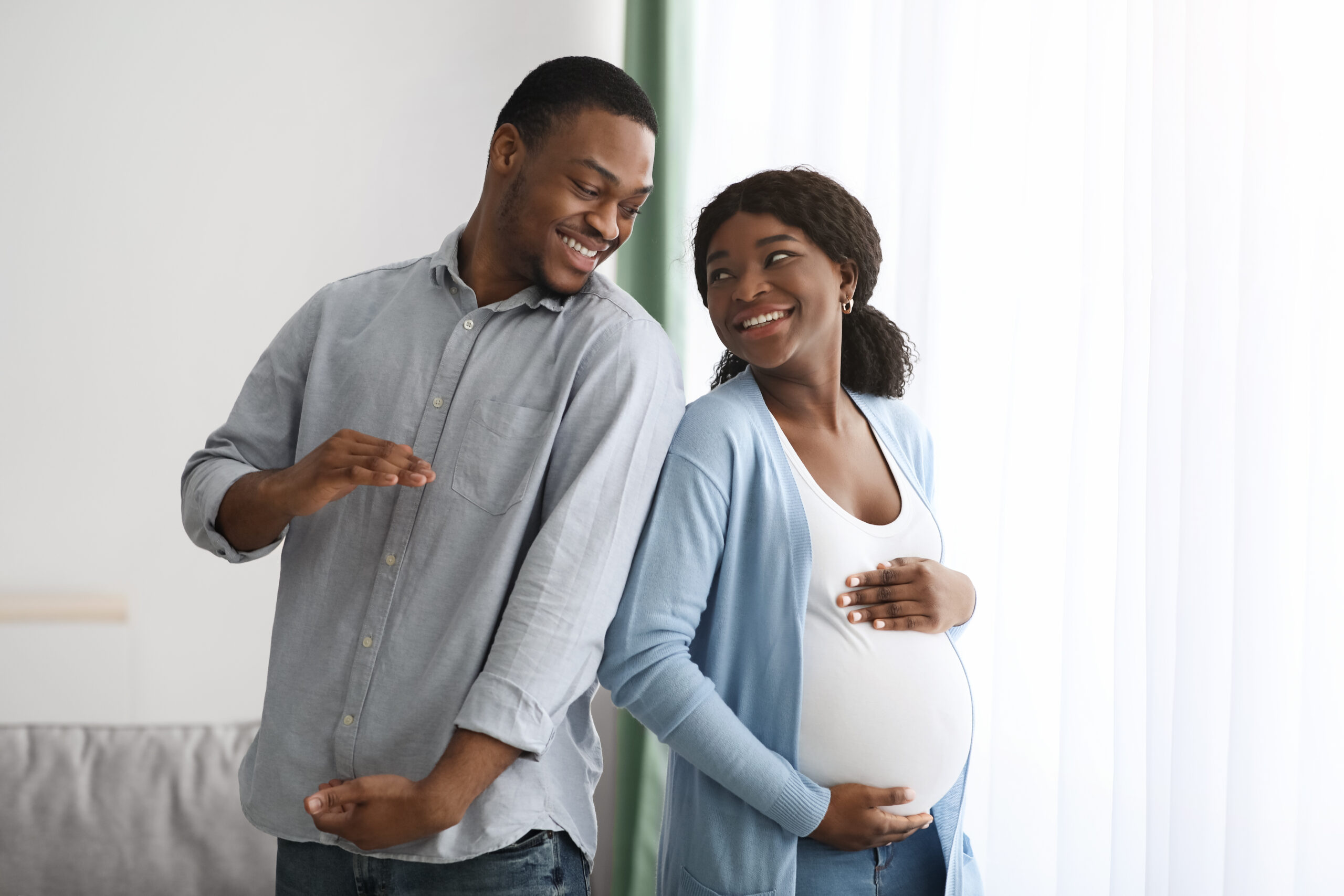 Loving,Black,Man,Imitating,His,Pregnant,Wife